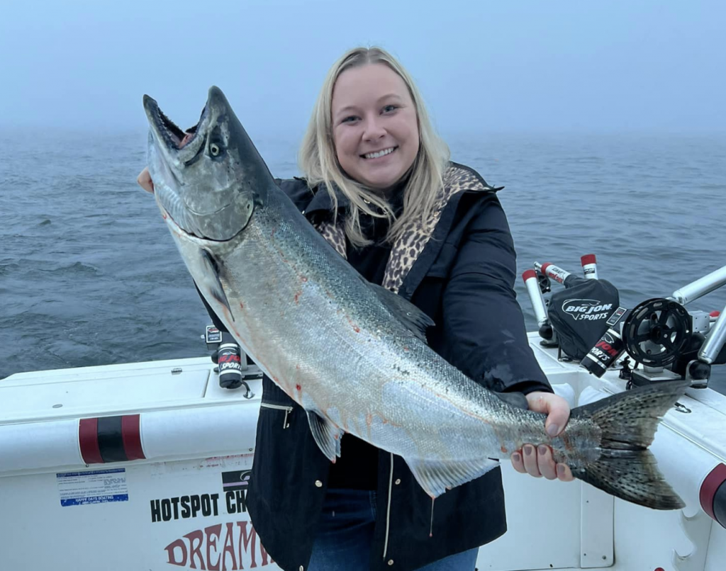 Daughter Lexi with her King Salmon Catch, fishing on Hot Spot Charters in Grand Haven Michigan
